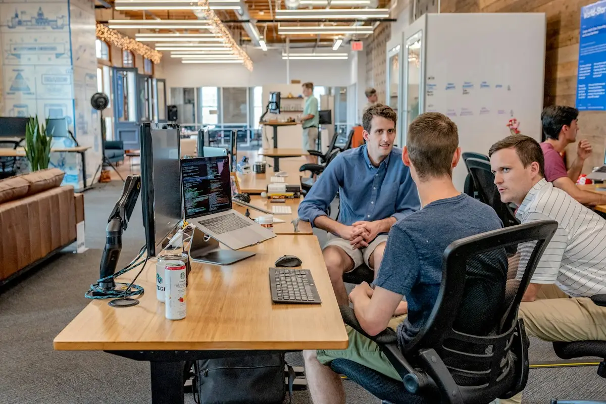 A team talking at desks in an open office