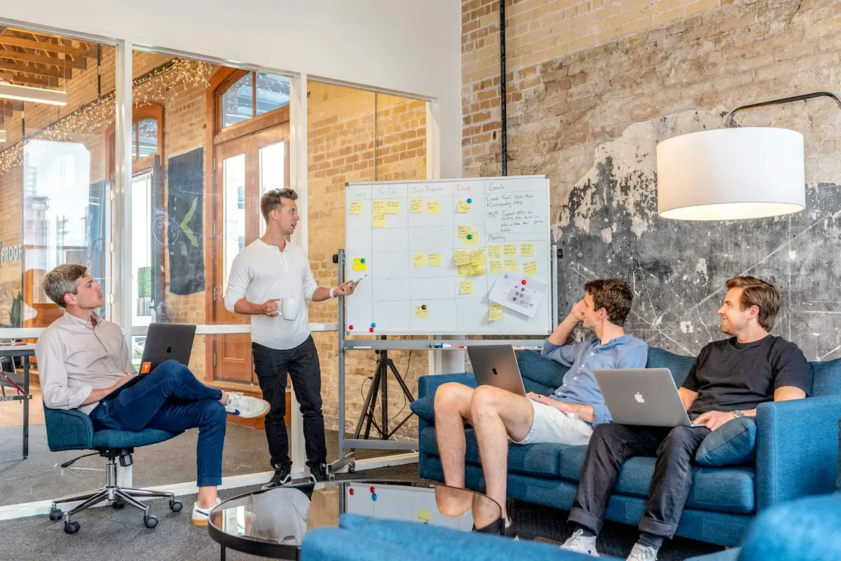 A team meeting in front of a whiteboard
