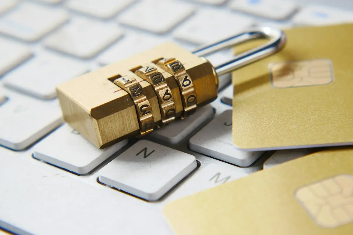 A combination padlock and bank cards resting on a keyboard