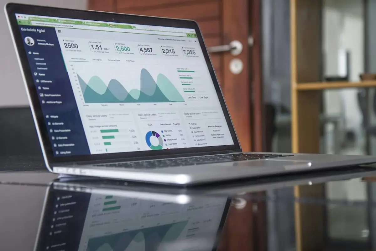 A laptop showing a website dashboard with traffic charts